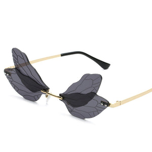 Sunglasses with a unique dragonfly frame design on a white background